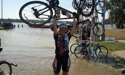 Cidney Dipping Her Bicycle in the Mississippi River after Finishing RAGBRAI